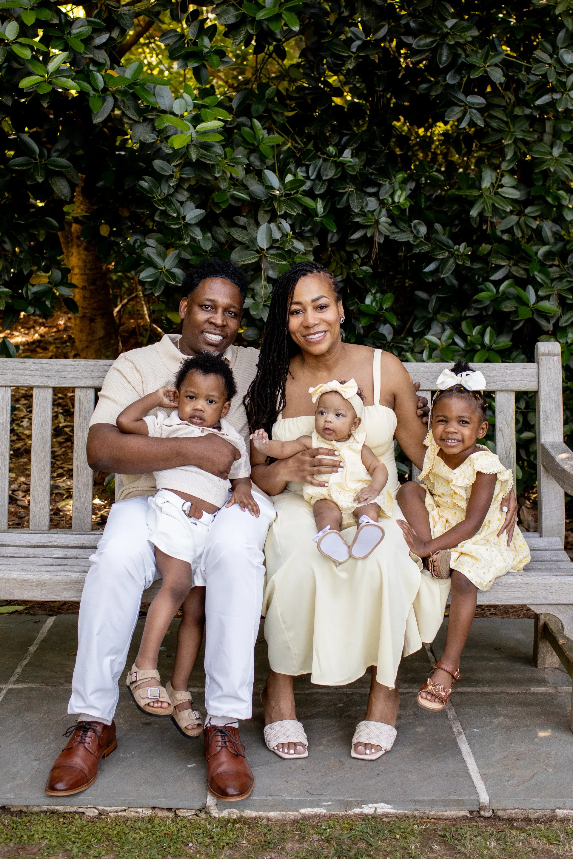 Darryl and Mary seated with their three children on a garden bench